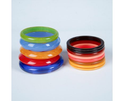 13 bangle bracelets in different sizes, colors, and materials. The largest one measures approximately 2.5"dia on the inside. 