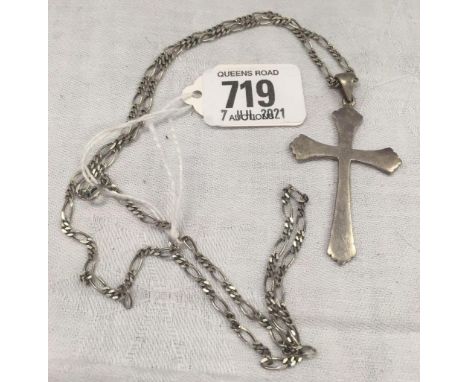 A SILVER CROSS ON A SILVER NECK CHAIN