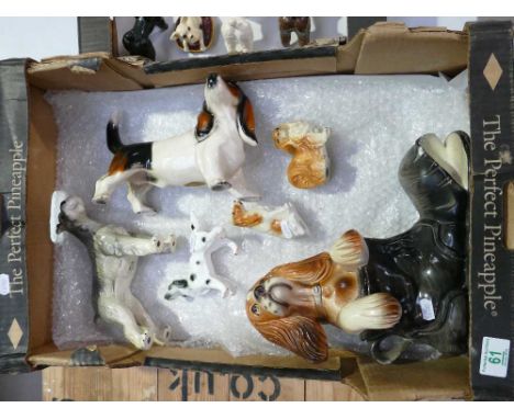 A collection of ceramic dogs to include Beagle , Setter, Puppy in a boot etc 