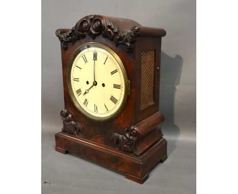 A William IV Mahogany Cased Bracket Clock with Carved Shaped Case, the enamel dial with Roman numerals and with twin fusee mo