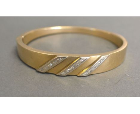 A 9ct. Gold Bangle set with Three Rows of Diamonds, 16.2 gms