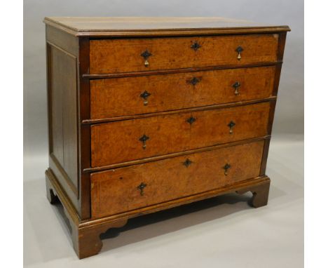 A George II Burr Walnut and Oak Chest, the moulded top above four long graduated drawers with brass drop handles and escutche