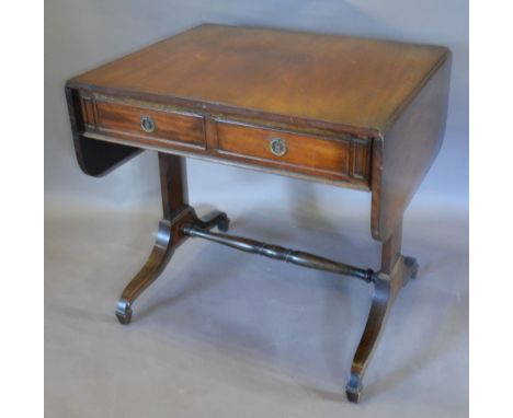 A Mahogany Drop Flap Sofa Table with two frieze drawers opposed by dummy drawers upon twin end supports with turned stretcher