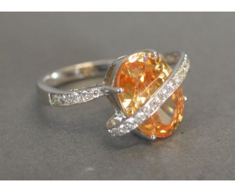 An 18ct. White Gold Diamond Ring set with a central cubic zirconia surrounded by diamonds, approximately 0.40 ct