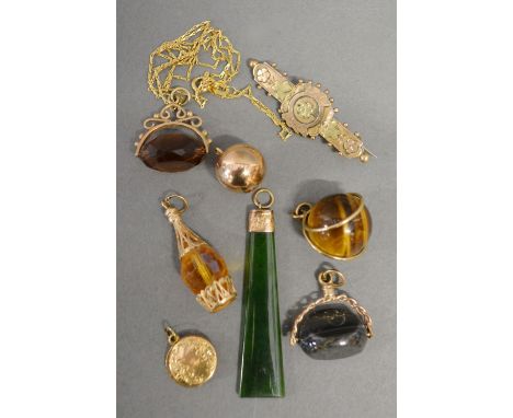 A 9ct. Gold Mounted Jade Pendant together with a 9ct. Gold Mounted Swivel Fob with Chain, four pendants and a 9ct. gold bar b