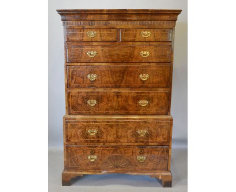 A George I Walnut Chest on Chest, the moulded cornice above two short and five long drawers, the bottom drawer with concave s