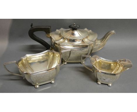 An Edwardian Silver Three Piece Tea Service comprising Teapot, Cream Jug and Two Handled Sucrier with engraved decoration, Bi