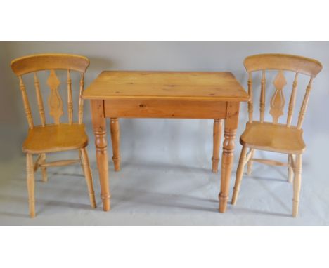 A Rectangular Pine Kitchen Table with End Drawer together with a pair of stick and splat back kitchen chairs