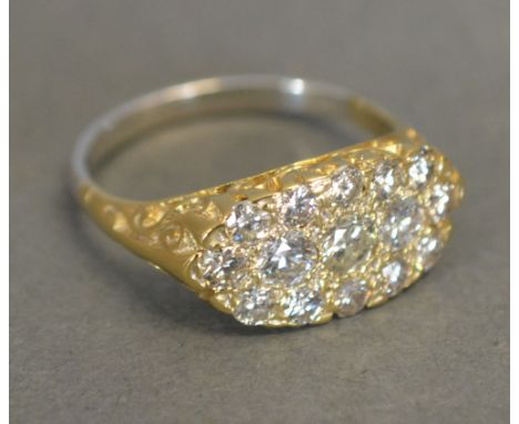 An 18ct. Yellow and White Gold Victorian Style Diamond Ring set many diamonds within a pierced setting
