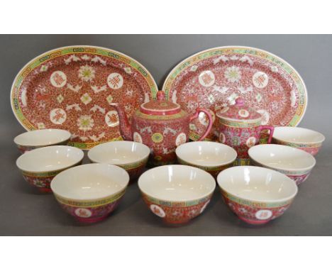 A Chinese Porcelain Service comprising nine tea bowls, a pair of oval platters, pot and covered cup, together with a small co