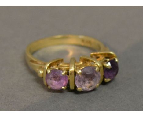 A 14ct. Gold Amethyst Three Stone Ring, claw set 