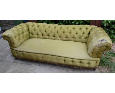 A Victorian Chesterfield Sofa with a Button Upholstered Back raised upon turned tapering legs, 214 cms long