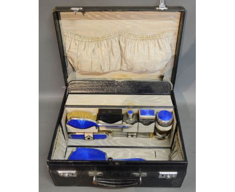 A Leather Travelling Case by Mappin & Webb, the hinged cover enclosing a fitted interior with various silver and guilloche en