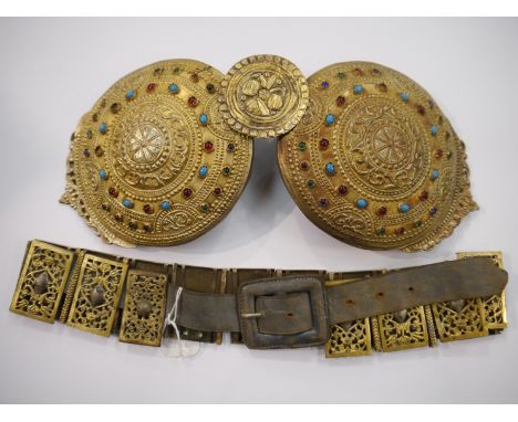 An Indian Colonial brass and white metal panelled belt, plaques have central cartouche with ornate foliate surround and an In