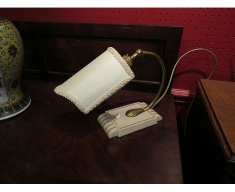 An Art Deco desk lamp in ivorene and brass with cream shade and adjustable head  