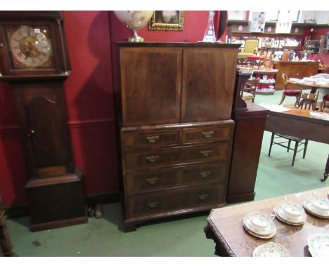 An 18th Century style cross banded figured walnut country house cabinet on chest, the two door cupboard over two short and th