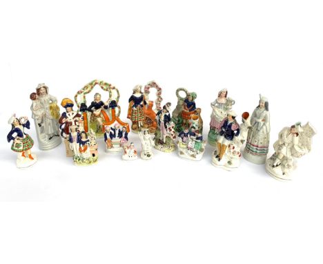 Sixteen Staffordshire figures to include; spill vase with mother and children reading, flat back of musician playing the lute