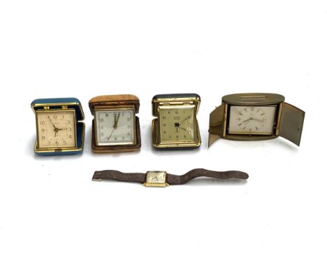 Four vintage cased travel clocks, to include Europa; together with a watch
