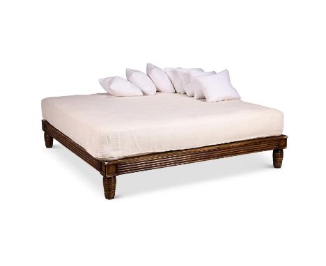 A carved and grained wood daybed, 20th century, together with a quantity of cushions, 190cm wide, 180cm deep, 55cm high (incl