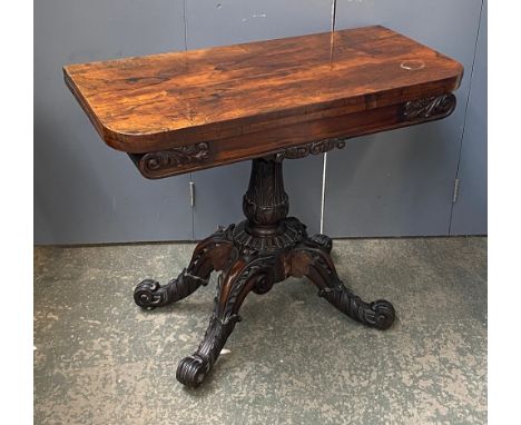A Victorian rosewood card table, the fold over top on carved column and four carved legs, 91.5x44x76cmH