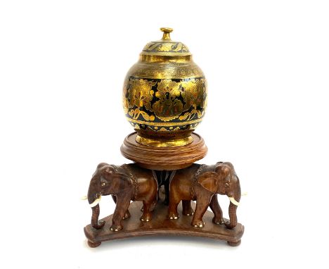 An Indian brass tea caddy on carved elephant stand, 36cmH altogether