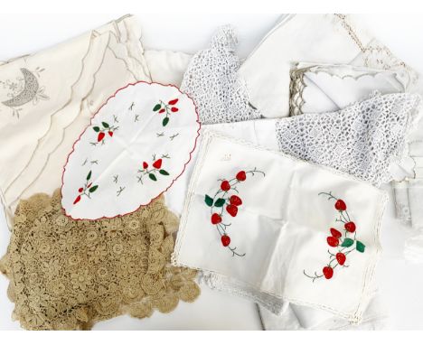 A quantity of table linens to include; hand embroidered tablecloths and placemats, bobbin lace floral place mats, moon patter
