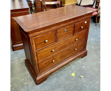 A John Lewis reproduction chest of drawers, having a cushion drawer, over three short and two long drawers, bracket feet, 115