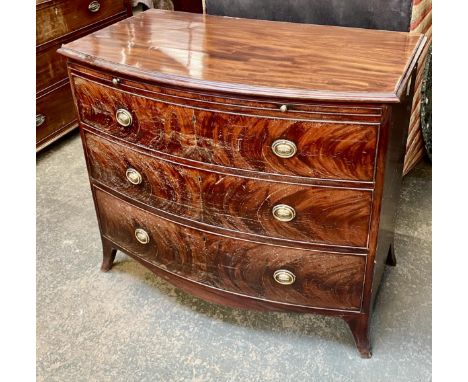 A George III bow front mahogany bachelors chest, the moulded top over a slide, and three graduating drawers, on swept bracket
