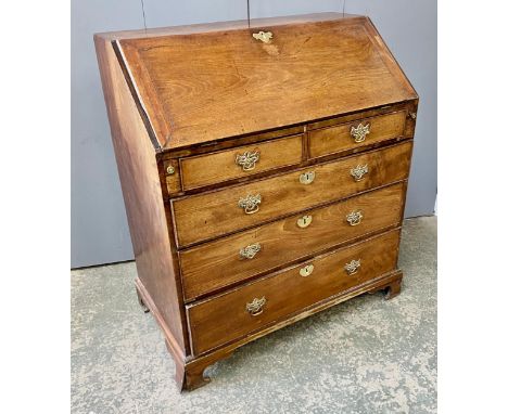 A George III mahogany bureau, the fall front opening to a fitted interior, above two short and three long drawers, on bracket