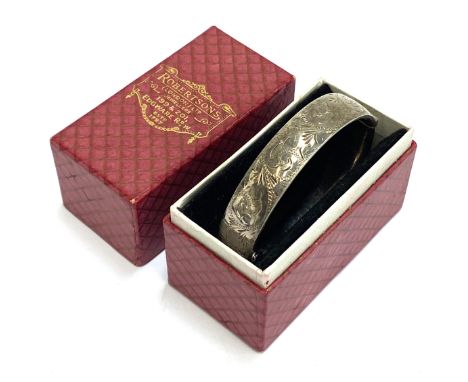 A silver bangle with engraved decoration, 6cm wide, hallmarked for London, Georg Jensen Ltd, 1975, 24.7g