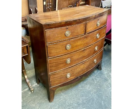 A 19th century bow front mahogany chest of two short over three long drawers, with pressed metal handles, over a shaped apron
