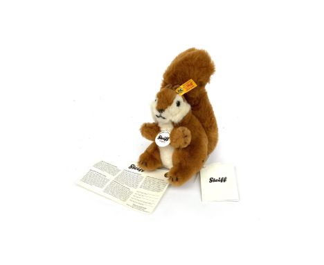 A Steiff stuffed red squirrel toy, tag to ear, 21cmH
