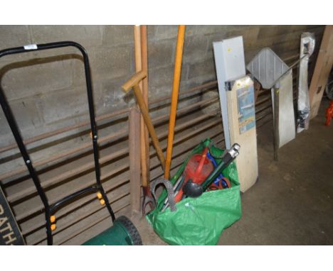 A quantity of long handled garden tools and a bag of various hoes, watering can etc.