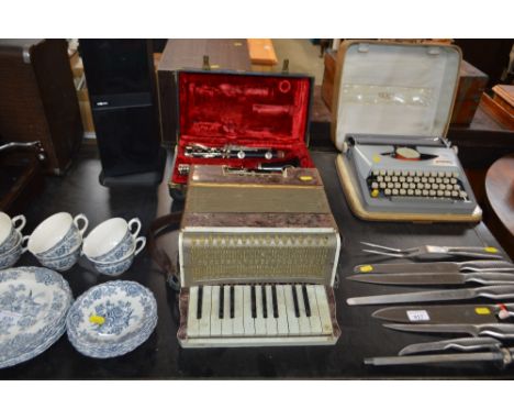 A Boosey &amp; Hawkes of London clarinet in fitted case, AF; together with a piano accordian