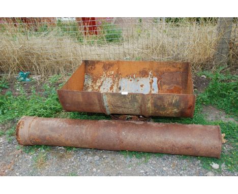 Metal half barrel on stand and a steel gate post
