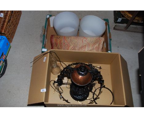 Two glass wastepaper bins, tablecloth and hanging electric light.
