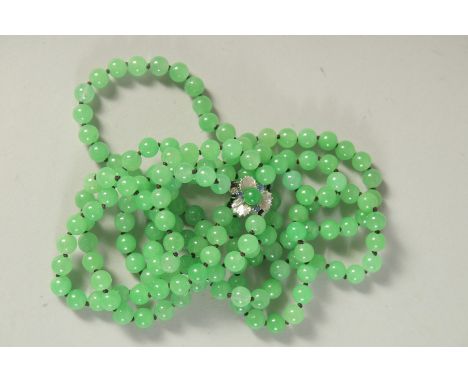 A GOOD DOUBLE ROW OF JADE BEADS with white gold clasp. 13ins long.