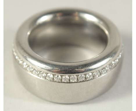 A HEAVY TITANIUM AND DIAMOND RING.