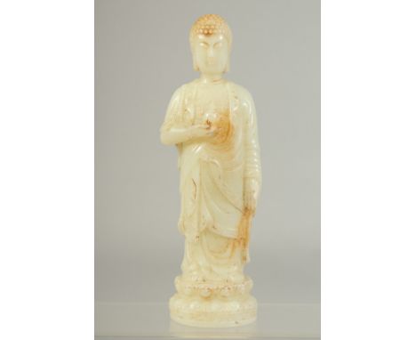 A CHINESE WHITE JADE CARVED FIGURE. 7.5ins high.