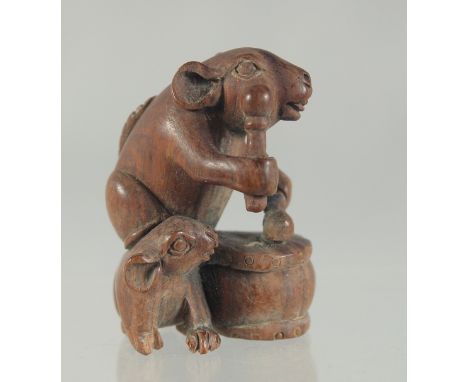 A CARVED WOOD RATS AND DRUM NETSUKE. 4.5cms.