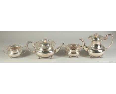 A VERY GOOD FOUR PIECE SILVER CIRCULAR TEA SET of pie crust design with shell mounts, comprising: tea pot, hot water jug, sug