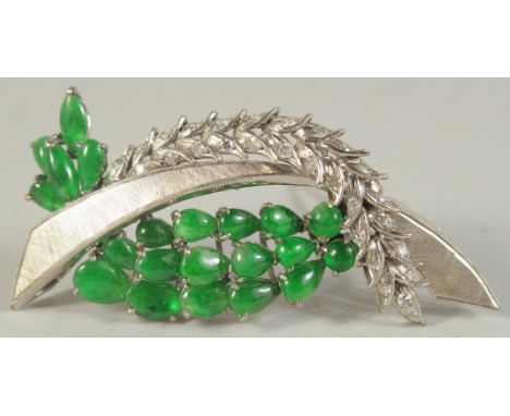 A WHITE METAL AND JADE BROOCH.