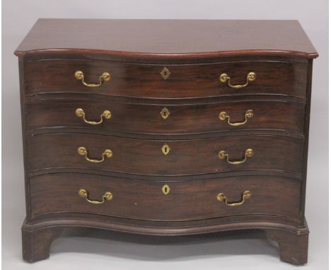 A SUPERB 18TH CENTURY MAHOGANY CHIPPENDALE SERPENTINE FRONTED COMMODE with four long graduated drawers, the top drawer filled