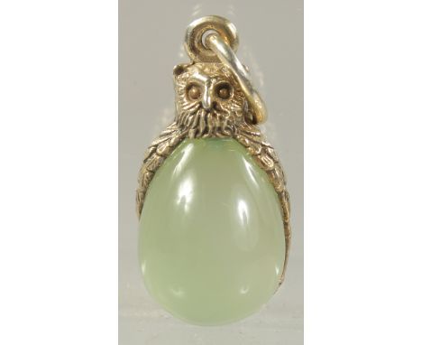 A SILVER AND JADE OWL PENDANT.