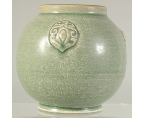 A CHINESE GREEN GLAZE POTTERY VASE with three moulded bosses. 11cm high.