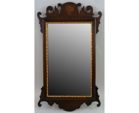 An early 20th century Chippendale style mahogany fretworked wall mirror, with inlaid circular batwing patera, 67 cm high.