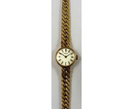 Tissot, a 9ct gold manual wind ladies wristwatch, London 1972, the silver dial with baton markings to an integral textured wo