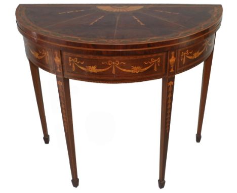 A Sheraton Revival mahogany half round fold over card table, the top with cross banding, marquetry and inlay over a frieze wi