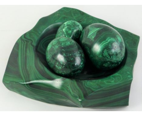 A malachite bowl, in the form of an irregularly shaped boulder with concave centre, max width 26cm and a graduated set of thr