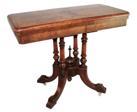 A late 19th/early 20th century walnut fold over card table, the swivelling canted oblong top quarter veneered and inlaid with